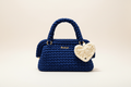 Full-frame navy blue crochet handbag with cream heart charm
