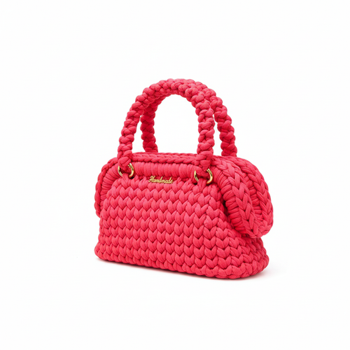 Bright pink handwoven handbag with braided handles and gold-tone hardware, left three-quarter view